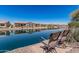 Picturesque waterfront view featuring comfortable patio chairs and serene water at 41960 W Ellington Ln, Maricopa, AZ 85138