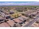 Expansive aerial view of a community showcasing well-maintained homes, landscaping, and community spaces under a blue sky at 44161 W Venture Ln, Maricopa, AZ 85139