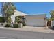 Charming desert home with a two-car garage, mature landscaping and flowers in front at 4708 E Euclid Ave, Phoenix, AZ 85044