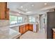 Bright kitchen with tile backsplash, wooden cabinets, and stainless steel appliances at 4708 E Euclid Ave, Phoenix, AZ 85044