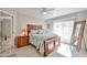 Bright main bedroom featuring a ceiling fan, and a large window letting in natural light at 4708 E Euclid Ave, Phoenix, AZ 85044