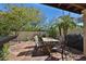 Relaxing patio featuring an outdoor dining table and chairs, complemented by mature trees and a well-maintained backyard at 4708 E Euclid Ave, Phoenix, AZ 85044