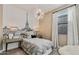 This bright, stylish bedroom offers an Eiffel Tower mural and eye-catching chandelier at 4927 S 106Th Ave, Tolleson, AZ 85353