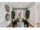 This elegant dining room features a large table with decorative wall art and greenery at 4927 S 106Th Ave, Tolleson, AZ 85353