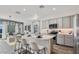 Inviting kitchen with gray cabinets, stainless steel appliances, a center island, and an open view to the living room at 4927 S 106Th Ave, Tolleson, AZ 85353
