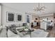 Open floor plan featuring a modern living room with stylish decor and an adjacent kitchen with gray cabinetry at 4927 S 106Th Ave, Tolleson, AZ 85353