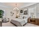 The spacious main bedroom boasts modern lighting, soft carpeting, and accent wall with marble design at 4927 S 106Th Ave, Tolleson, AZ 85353