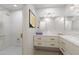 Bright bathroom featuring dual sinks, a large mirror, and a glass-enclosed shower at 5032 N 78Th St, Scottsdale, AZ 85250