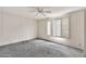 This bedroom has a ceiling fan and window shutters at 5032 N 78Th St, Scottsdale, AZ 85250