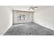 Empty bedroom featuring a window, ceiling fan, and carpet flooring at 5032 N 78Th St, Scottsdale, AZ 85250