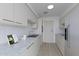 Modern kitchen featuring white cabinetry, marble countertops, and stainless steel appliances at 5032 N 78Th St, Scottsdale, AZ 85250