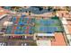 Aerial view of pickleball and tennis courts near parking and a tranquil pond, offering recreational amenities at 540 Leisure World --, Mesa, AZ 85206