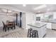Open kitchen with stainless appliances, white cabinetry, subway tile backsplash, and large island with seating at 540 Leisure World --, Mesa, AZ 85206