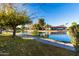 Scenic view of a tranquil pond with a walking path in a community at 540 Leisure World --, Mesa, AZ 85206