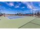 Well-maintained tennis court with green and blue surface, surrounded by a black fence, under a clear blue sky at 540 Leisure World --, Mesa, AZ 85206