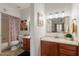 Well-lit bathroom featuring a wood vanity, sink, and colorful shower curtain offers modern comfort and style at 5757 W Eugie Ave # 2081, Glendale, AZ 85304