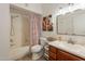 Bright bathroom featuring tub and shower with a wood vanity and sink offers a comfortable and practical space at 5757 W Eugie Ave # 2081, Glendale, AZ 85304