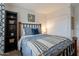 Inviting bedroom featuring a window, comfortable bed, and storage shelf provides a relaxing retreat at 5757 W Eugie Ave # 2081, Glendale, AZ 85304