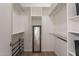 Bright closet with custom shelving, metal racks, and a full-length mirror offers an organized storage solution at 5757 W Eugie Ave # 2081, Glendale, AZ 85304