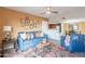Comfortable living room with blue sofa, decorative pillows, and a stylish rug with access to the Kitchen at 5757 W Eugie Ave # 2081, Glendale, AZ 85304
