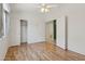 Bedroom with hardwood flooring, ceiling fan, and closet with sliding doors at 5867 W Cochise Dr, Glendale, AZ 85302