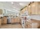 A well-appointed kitchen featuring neutral cabinetry and stainless-steel appliances at 5867 W Cochise Dr, Glendale, AZ 85302