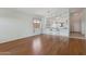 Open-concept living space with wood floors, bar seating and adjacent kitchen at 5867 W Cochise Dr, Glendale, AZ 85302
