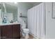 Clean bathroom features a vanity with a dark wood finish and a shower with a curtain at 6618 S 54Th Ln, Laveen, AZ 85339