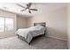 Cozy bedroom featuring a ceiling fan, neutral color pallet, and ample natural light at 6618 S 54Th Ln, Laveen, AZ 85339