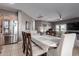 Dining area adjacent to kitchen features a long table, seating and stainless fridge at 6618 S 54Th Ln, Laveen, AZ 85339