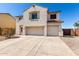 Charming two-story home featuring a three-car garage and landscaped front yard at 6618 S 54Th Ln, Laveen, AZ 85339