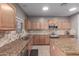 Well-equipped kitchen with granite counters, island, tile backsplash, and stainless steel appliances at 6618 S 54Th Ln, Laveen, AZ 85339