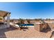 Scenic backyard with a sparkling pool, outdoor kitchen, and beautiful desert views, ideal for relaxation at 6618 S 54Th Ln, Laveen, AZ 85339