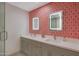 Elegant bathroom with a double sink vanity, unique wallpaper, and modern mirrors at 6746 E Monterosa St, Scottsdale, AZ 85251