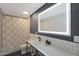 Bright bathroom featuring subway tile, an illuminated mirror, and dark hardware at 6746 E Monterosa St, Scottsdale, AZ 85251