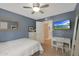 Comfortable bedroom with hardwood floors, a white bed, desk, and blue accent wall at 6746 E Monterosa St, Scottsdale, AZ 85251