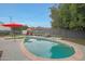 Relaxing pool area with lounge chairs and a red umbrella, perfect for enjoying sunny days at 6746 E Monterosa St, Scottsdale, AZ 85251