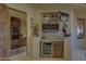 Elegant bar area complete with custom cabinetry, a wine fridge, and display shelving at 7373 E Clubhouse Dr # 24, Scottsdale, AZ 85266