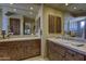 Bright bathroom featuring and vanity sinks, a tiled backsplash, and glass block windows at 7373 E Clubhouse Dr # 24, Scottsdale, AZ 85266