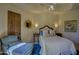 Cozy bedroom with neutral walls, a queen bed with patterned pillows, and an upholstered chair at 7373 E Clubhouse Dr # 24, Scottsdale, AZ 85266