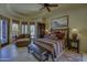 Bedroom with a sitting area, king bed, ceiling fan and tile floors at 7373 E Clubhouse Dr # 24, Scottsdale, AZ 85266
