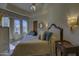 Comfortable bedroom featuring bay window, ceiling fan, and decorative wall sconces at 7373 E Clubhouse Dr # 24, Scottsdale, AZ 85266