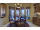 Cozy breakfast nook featuring a round wooden table with seating and view of the patio at 7373 E Clubhouse Dr # 24, Scottsdale, AZ 85266