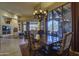 Dining area adjacent to the living room featuring a decorative chandelier and floor to ceiling windows at 7373 E Clubhouse Dr # 24, Scottsdale, AZ 85266