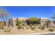 Desert home featuring unique architecture, native landscaping, and neutral earth tone color palette on a sunny day at 7373 E Clubhouse Dr # 24, Scottsdale, AZ 85266