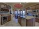 Open kitchen with granite island, stainless appliances, custom cabinets, plus adjacent dining area and bar at 7373 E Clubhouse Dr # 24, Scottsdale, AZ 85266
