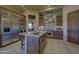 Spacious kitchen featuring a large island, stainless steel appliances, and custom wood cabinetry at 7373 E Clubhouse Dr # 24, Scottsdale, AZ 85266