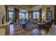 Living room with a fireplace, hardwood floors, comfortable seating, and expansive windows showcasing the outdoor view at 7373 E Clubhouse Dr # 24, Scottsdale, AZ 85266