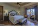 Relaxing main bedroom with hardwood floors, bench, and a view of the outdoor space at 7373 E Clubhouse Dr # 24, Scottsdale, AZ 85266