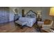 Serene main bedroom with hardwood floors, a decorative bench, and view of the outdoor space at 7373 E Clubhouse Dr # 24, Scottsdale, AZ 85266